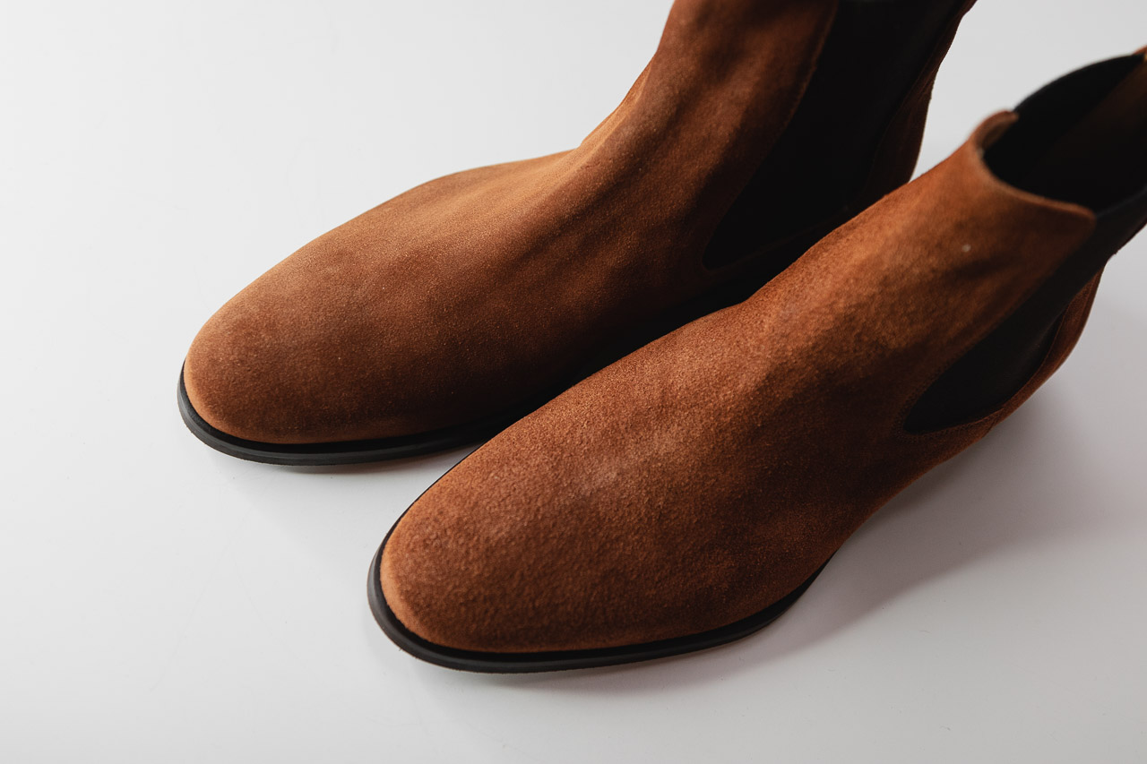 top down view of brown chelsea boots in water repellent suede
