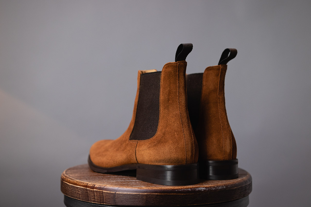 heel view of brown chelsea boots in water repellent suede