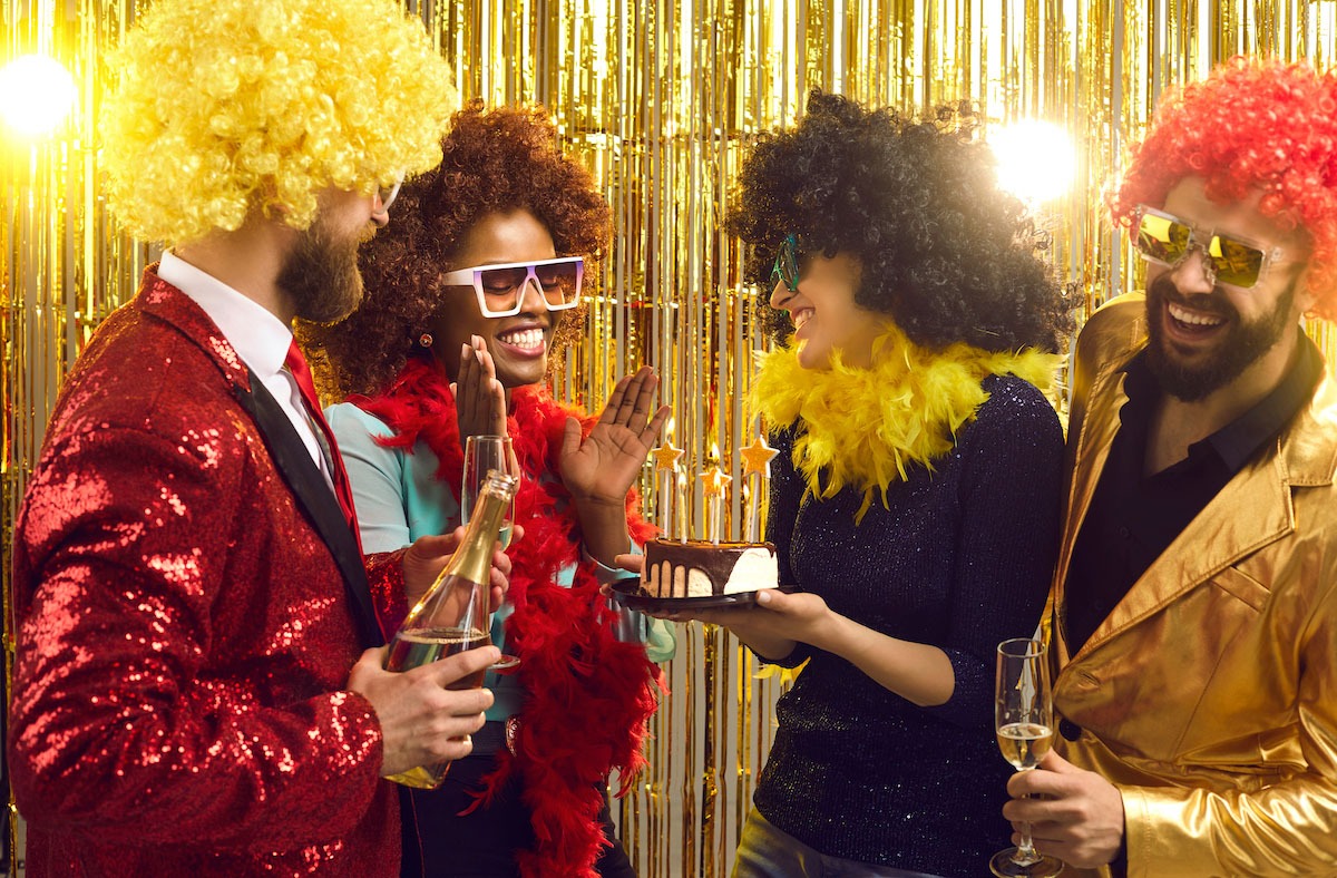 4 friends at a theme party wearing wigs