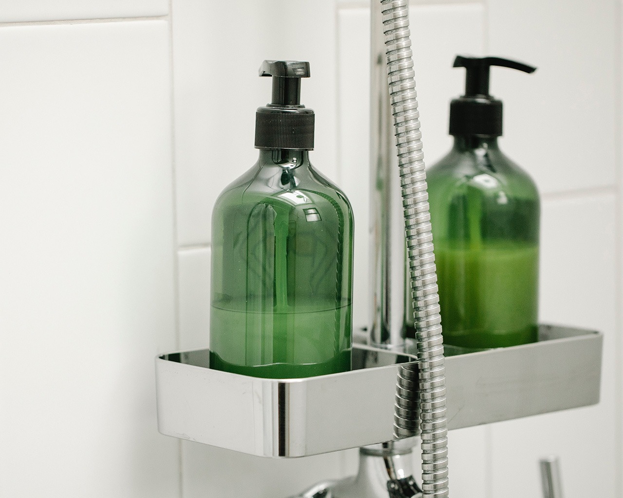 green bottles on shower caddy