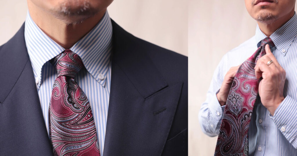 closeup of paisley tie with blue striped shirt and navy suit
