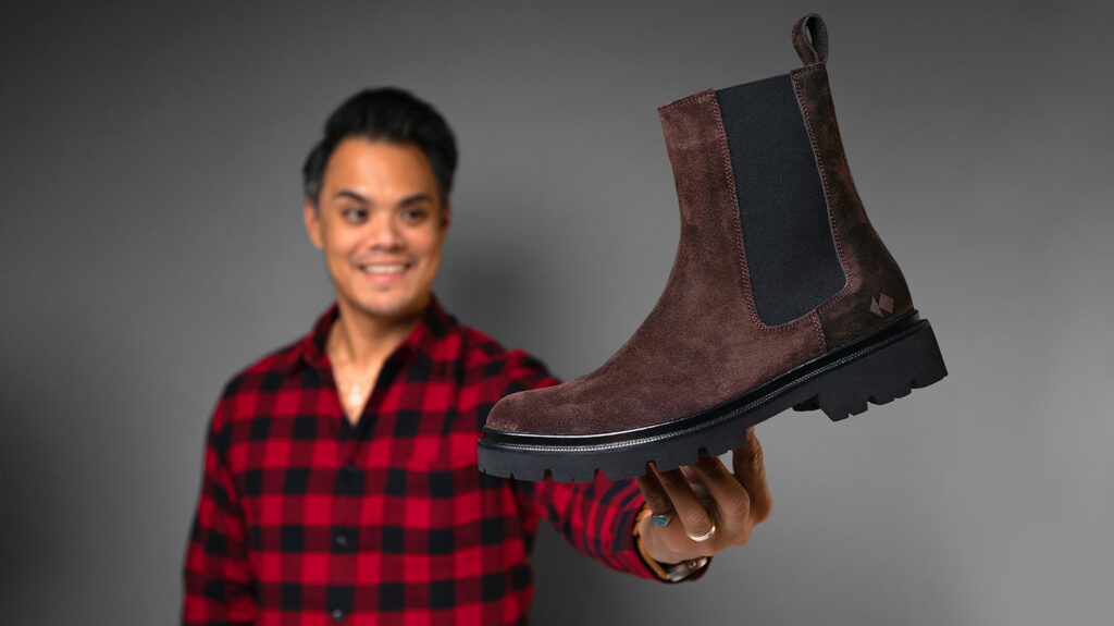 man holding brown koio chelsea boots